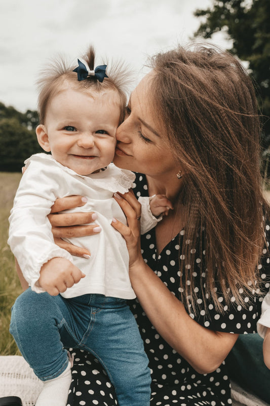 mother-kissing-happy-little-daughter